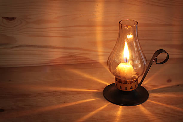 istock burning candle it a wooden wall. 188000190