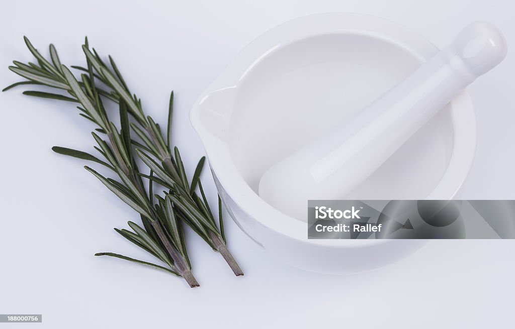 Mortar pestle and rosemary Mortar and pestle isolated on white background Blender Stock Photo