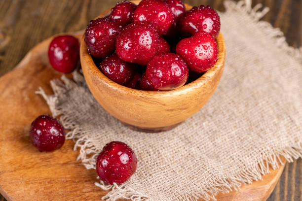 istock covered with drops of water ripe red cherries on the table 1880026198