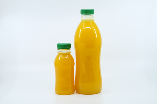 Fresh orange juice served in bottle isolated on background side view of healthy morning juice drink