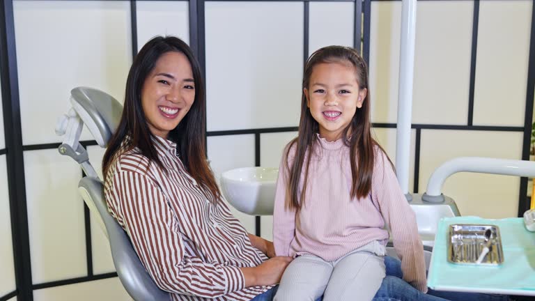 Cute girl with her mom at the dentist's office