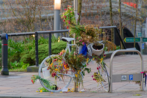 Memorial flowers on bicycle where woman was hit by a car and died in Glasgow UK