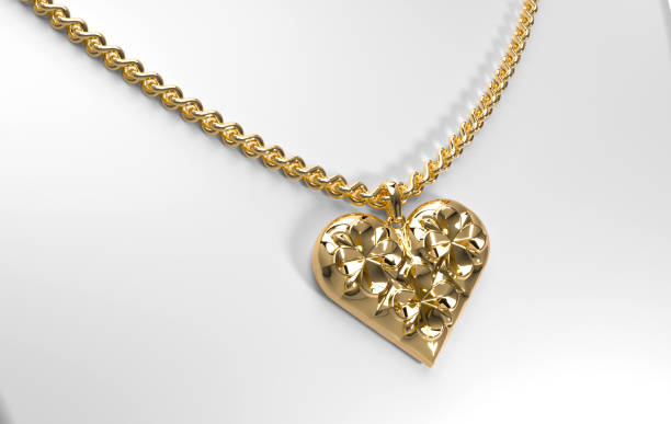 istock Gold heart-shaped pendant with floral pattern on a chain 1880080196
