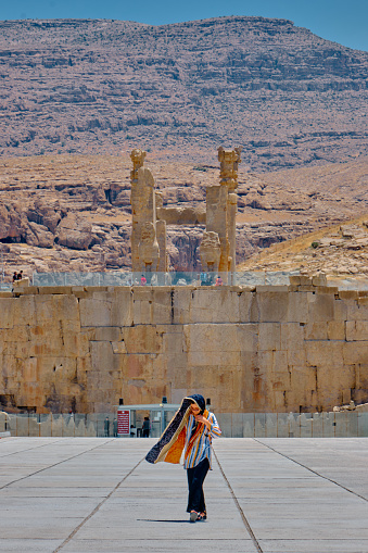 Persepolis, Iran-June 27, 2023: Entrance of Persepolis with iranian women.