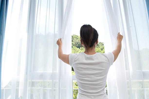 istock Woman opening white see-through curtains 188011413