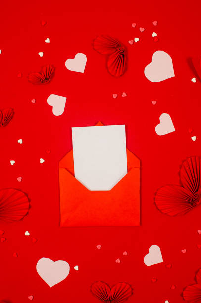 istock Red envelope with blank card, gift box and hearts on red background. 1880140303