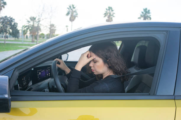 istock Woman with headache is driving. 1880141846