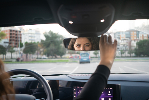 Adjusting rear view mirror. Safety concept