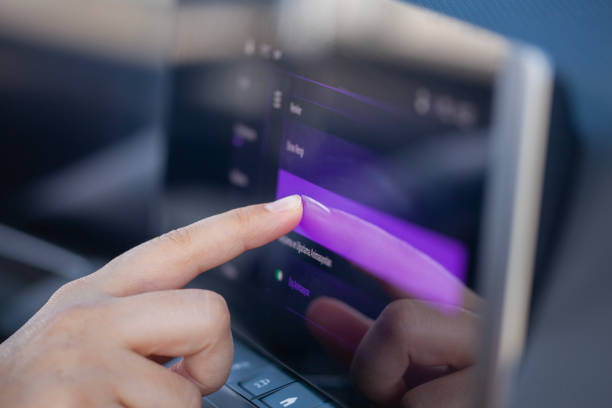 Driver touching car screen and adjusts Automatic driving. Futuristic Concept.