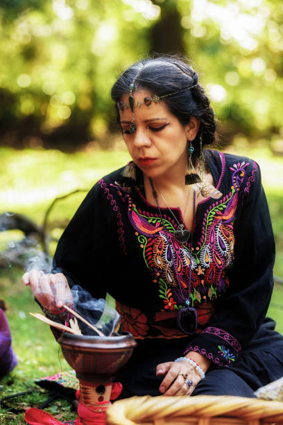 istock Mexican holistic healer lights a incense burner for a ritual VIII 1880164454