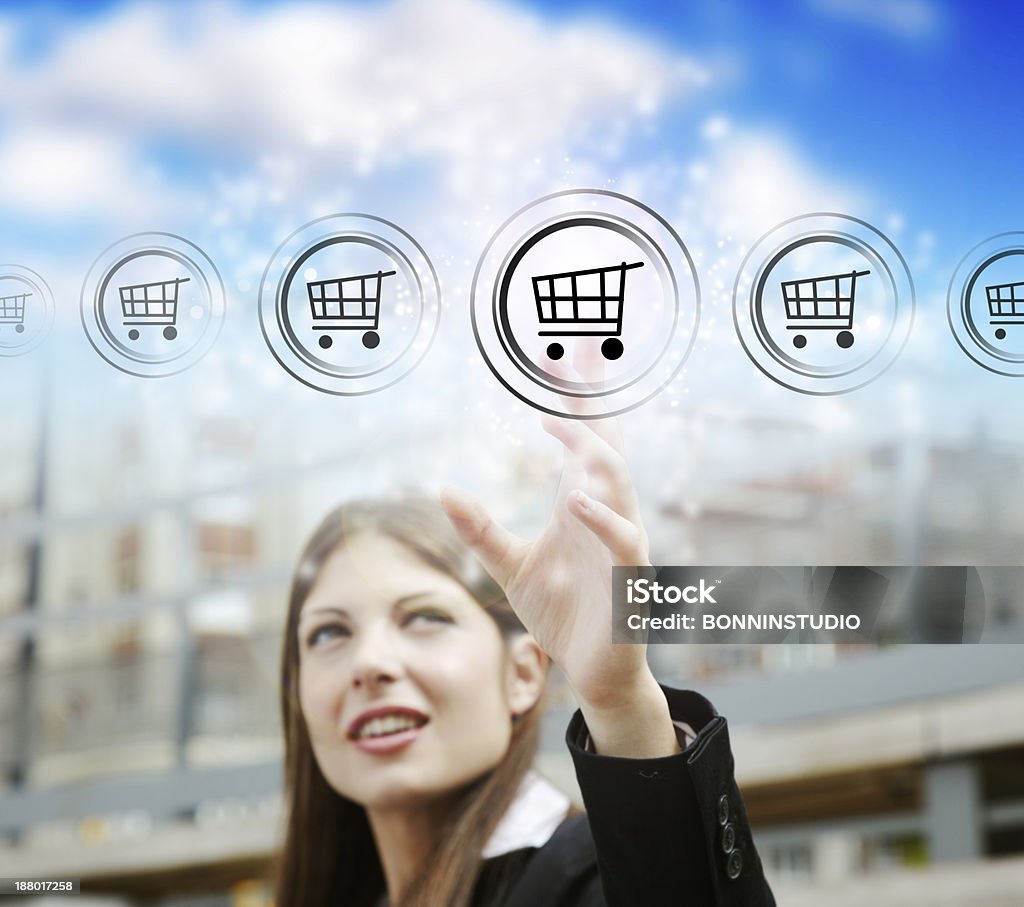Businesswoman pressing symbol of modern online marketing and shopping Young businesswoman pressing cart button. Adult Stock Photo