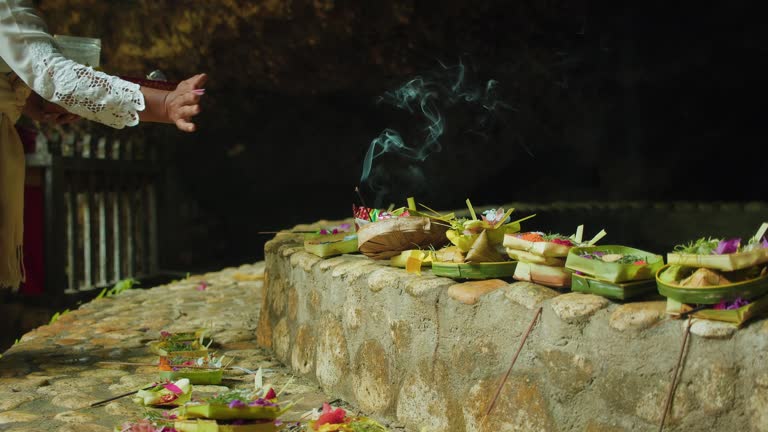 Balinese woman performs a ceremony of offerings to Hindu God