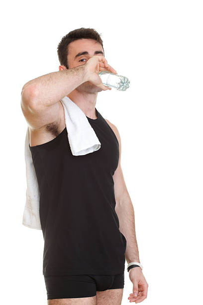 istock smiling young man holding towel bottle water isolated background 188026701
