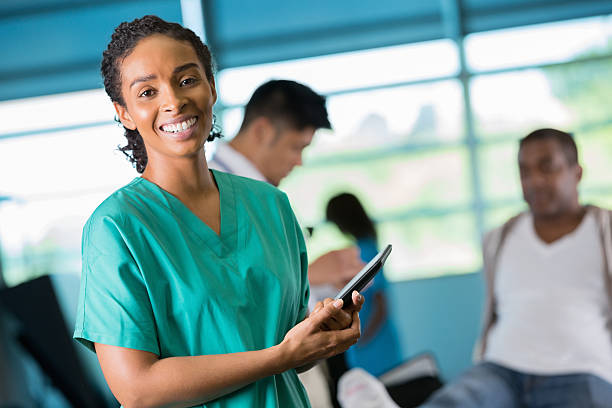 istock Nurse using digital tablet in rehabilitation physical therapy hospital 188026879