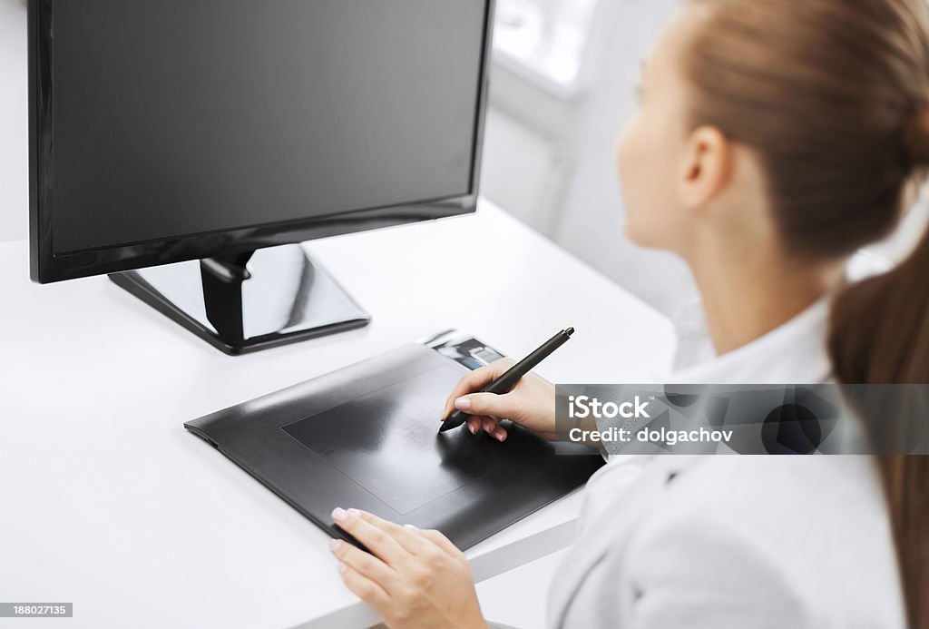 businesswoman with drawing tablet in office business, office, school and education concept - smiling businesswoman with drawing tablet in office Adult Stock Photo