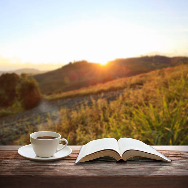 istock Cup of coffee and a book on wooden table 188027898
