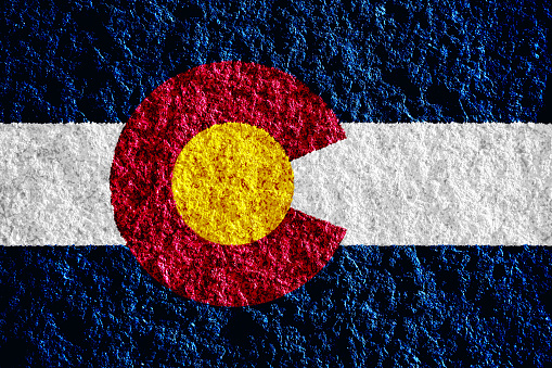Flag of Colorado USA state on a textured background. Concept collage.