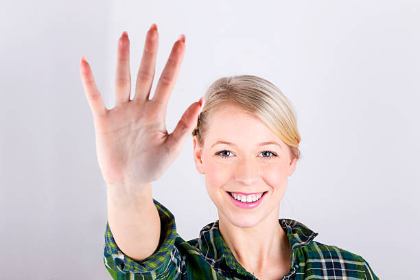 istock Attractive Blond Girl Showing Open Hand 188030706