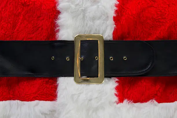 Santa Claus' red and white furry coat with a black belt and brass buckle