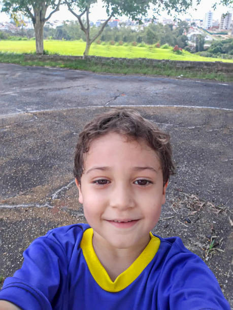 Cheerful boy taking a selfie in a public city park. The photo was taken in the State of São Paulo.