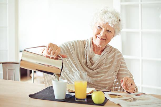 istock Cheerful Grandma at Home Having Breakfast 188037166