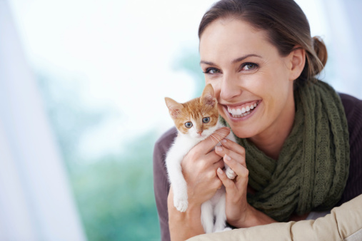 Shot of an attractive young woman holding a kitten