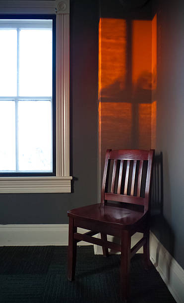 Chair with sunset window glow stock photo