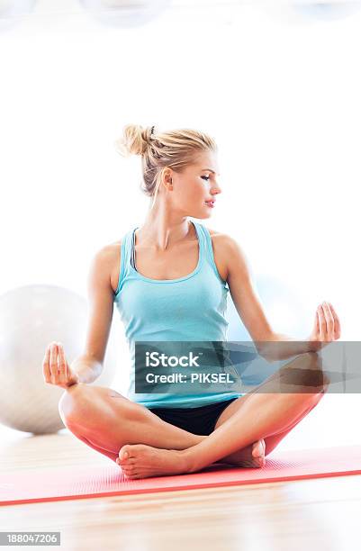 Woman Sitting In Lotus Position Stock Photo - Download Image Now - Adult, Adults Only, Balance