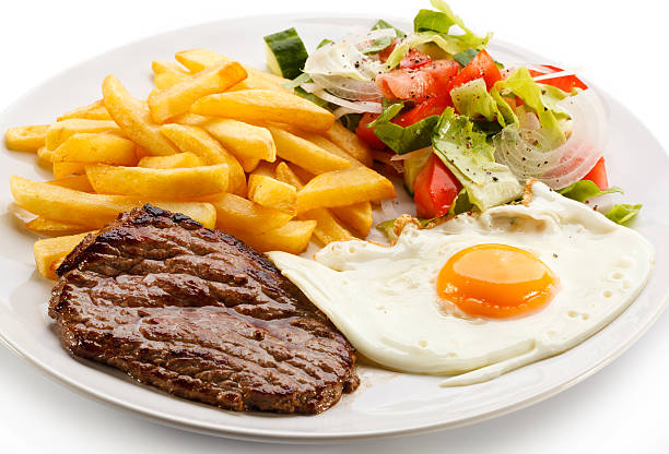 istock Beefsteak, fried egg, French fries and vegetables 188048982