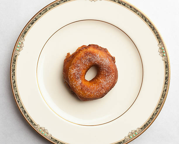 Homemade doughnut on fine china plate stock photo