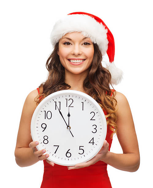 istock woman in santa helper hat with clock showing 12 188049367