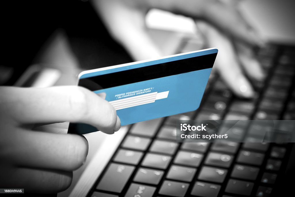 Online shopping with credit card on laptop Hands entering credit card information into a laptop ATM Stock Photo