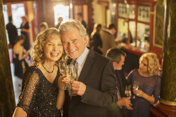 portrait of well dressed couple toasting champagne flutes - luxury glamour dress caucasian imagens e fotografias de stock