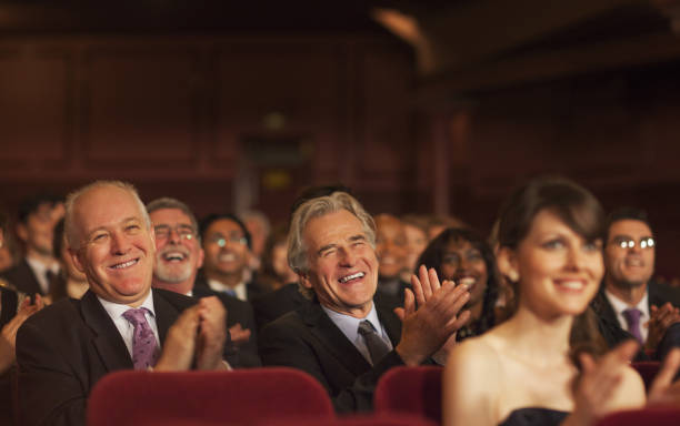 istock Theater audience laughing and clapping 188051689