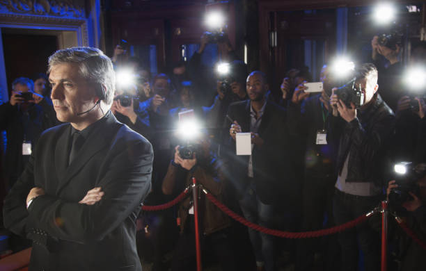 istock Paparazzi using flash photography behind bodyguard at red carpet event 188051708