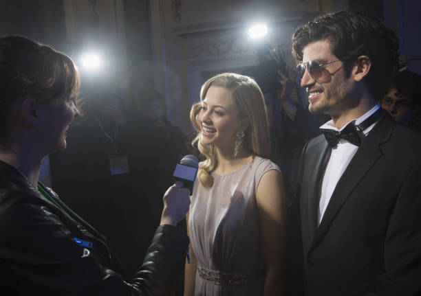 istock Well dressed celebrity couple being interviewed at red carpet event 188051752