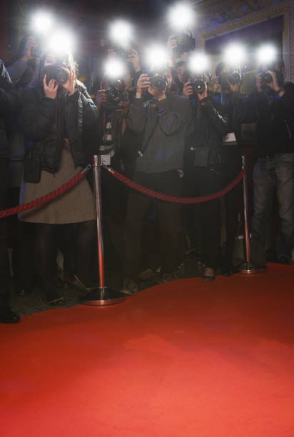 paparazzi utilizando fotos de flash en la alfombra roja - front view flash fotografías e imágenes de stock