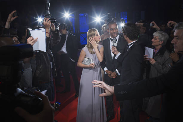 istock Well dressed celebrity couple being interviewed on red carpet 188051781