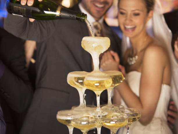 istock Groom pouring champagne pyramid at wedding reception 188051799