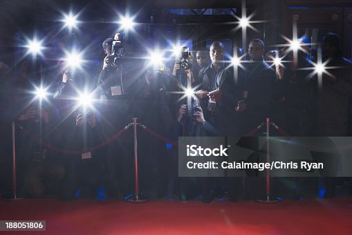 istock Paparazzi using flash photography behind rope on red carpet 188051806