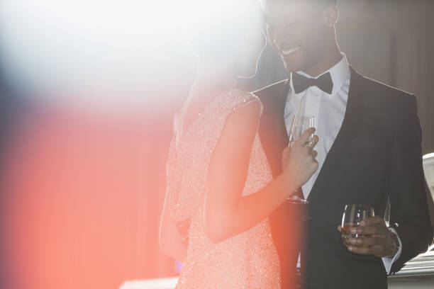 istock Well dressed couple drinking champagne and cocktail 188051866
