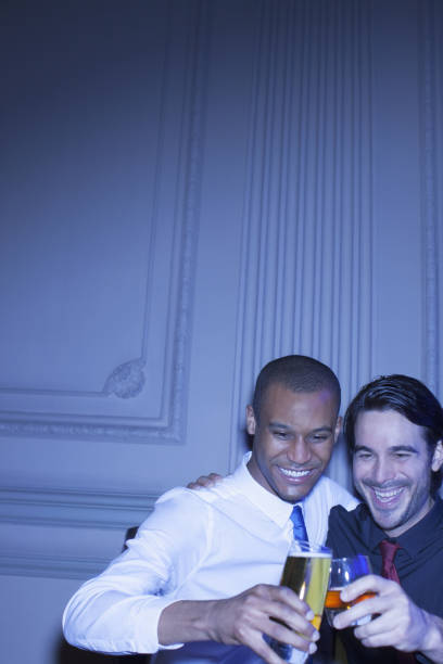 istock Well dressed men hugging and toasting beer and cocktail 188051909