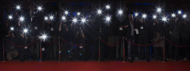 paparazzi using flash photography along red carpet - front view flash 뉴스 사진 이미지