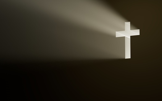 Siluette of Christian woman  holding a bible and wooden Christian cross necklace while praying to God.