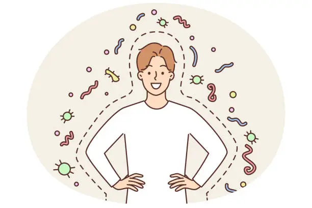 Vector illustration of Happy man with good immunity smiling and holding hands on belt standing among bacteria and parasites