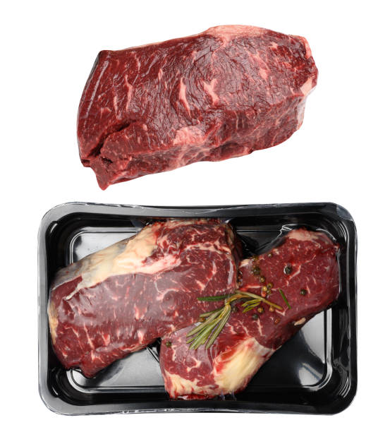 istock Two raw beef steaks in a plastic container with spices and vacuumized on a white background, packaging for long-term storage 1880613403