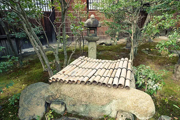 zen garden fragment with stone lantern and closed draw-well