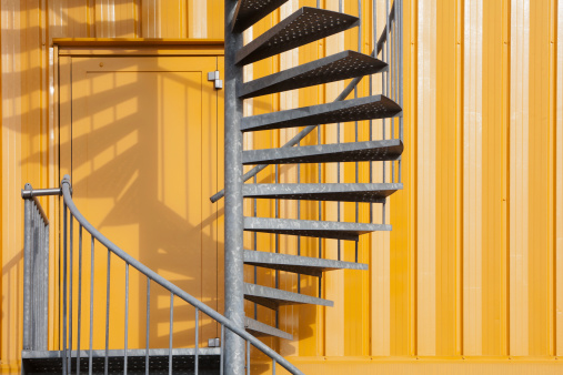 Yellow building with spiral metal staircase
