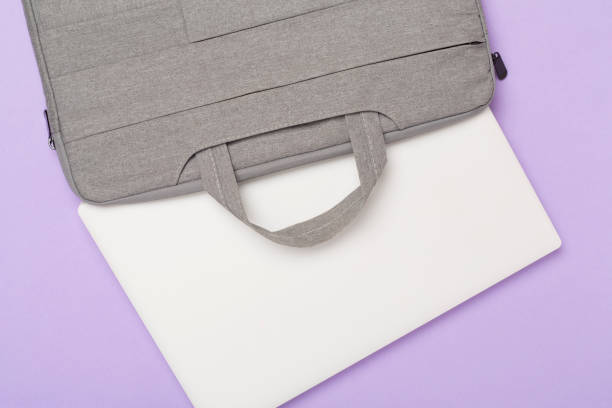 istock Grey stylish laptop bag with device on color background,top view 1880673052