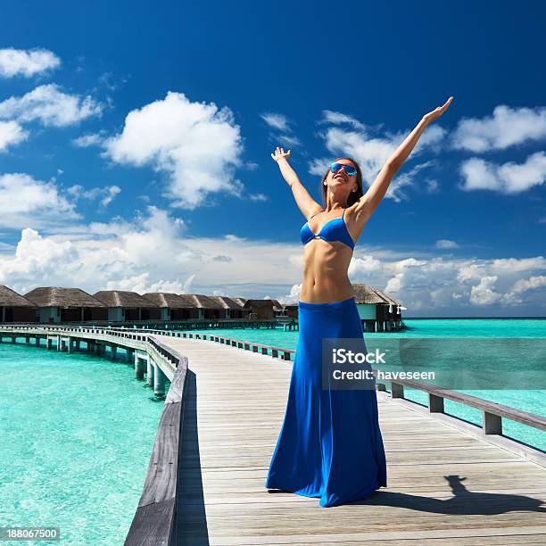 Woman On A Beach Jetty At Maldives Stock Photo - Download Image Now - Adult, Arms Outstretched, Beach